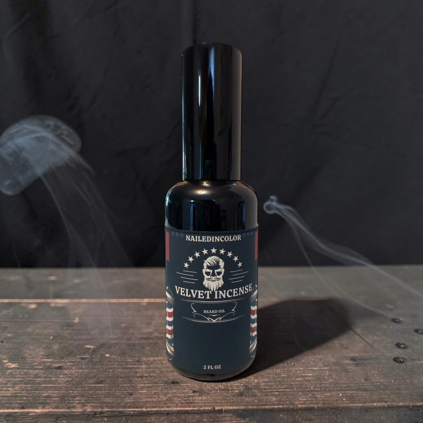 A bottle of Nailed In Color Velvet Incense standing on a rustic wooden surface with smoke effects against a dark background.