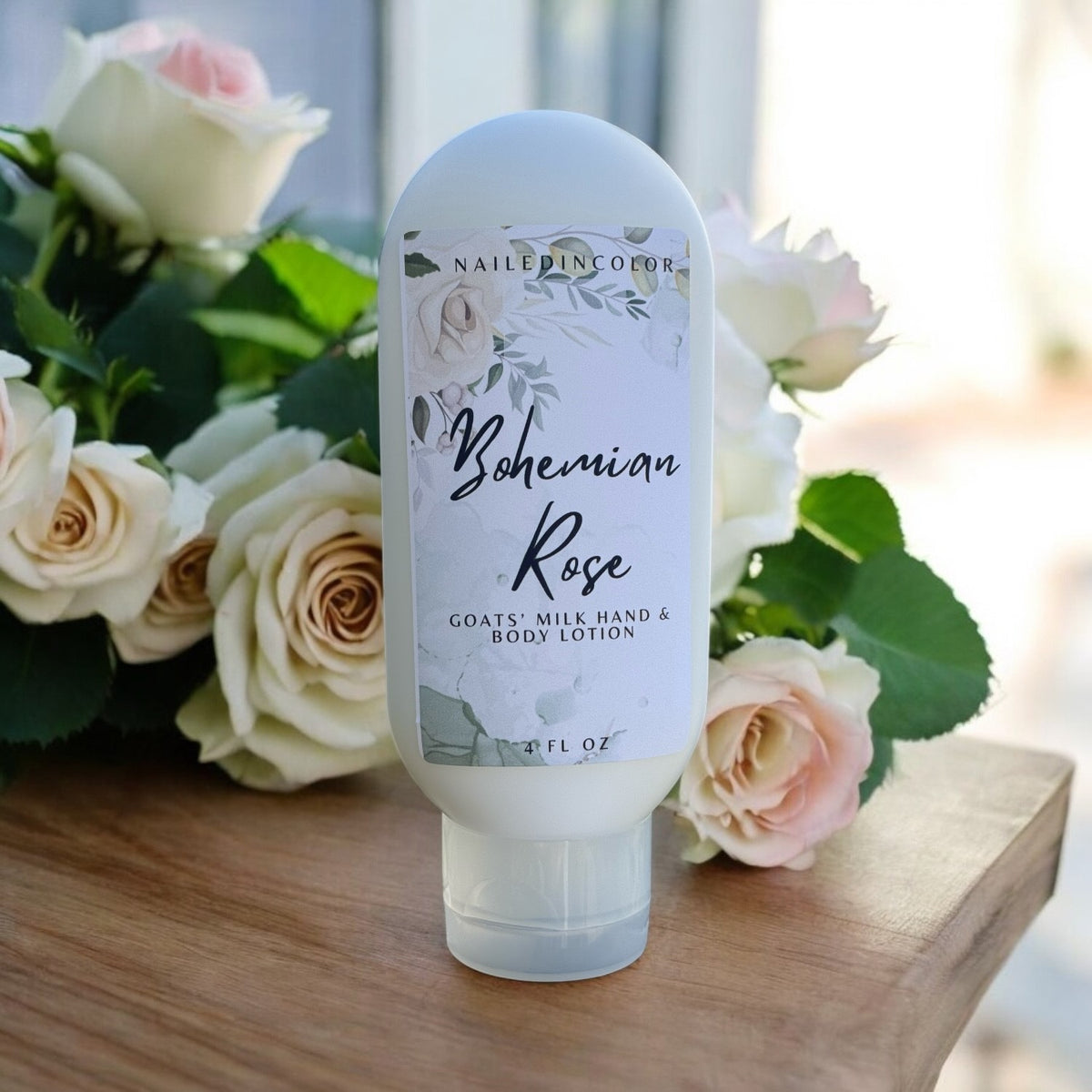 bohemian rose lotion next to a bouquet of pale roses