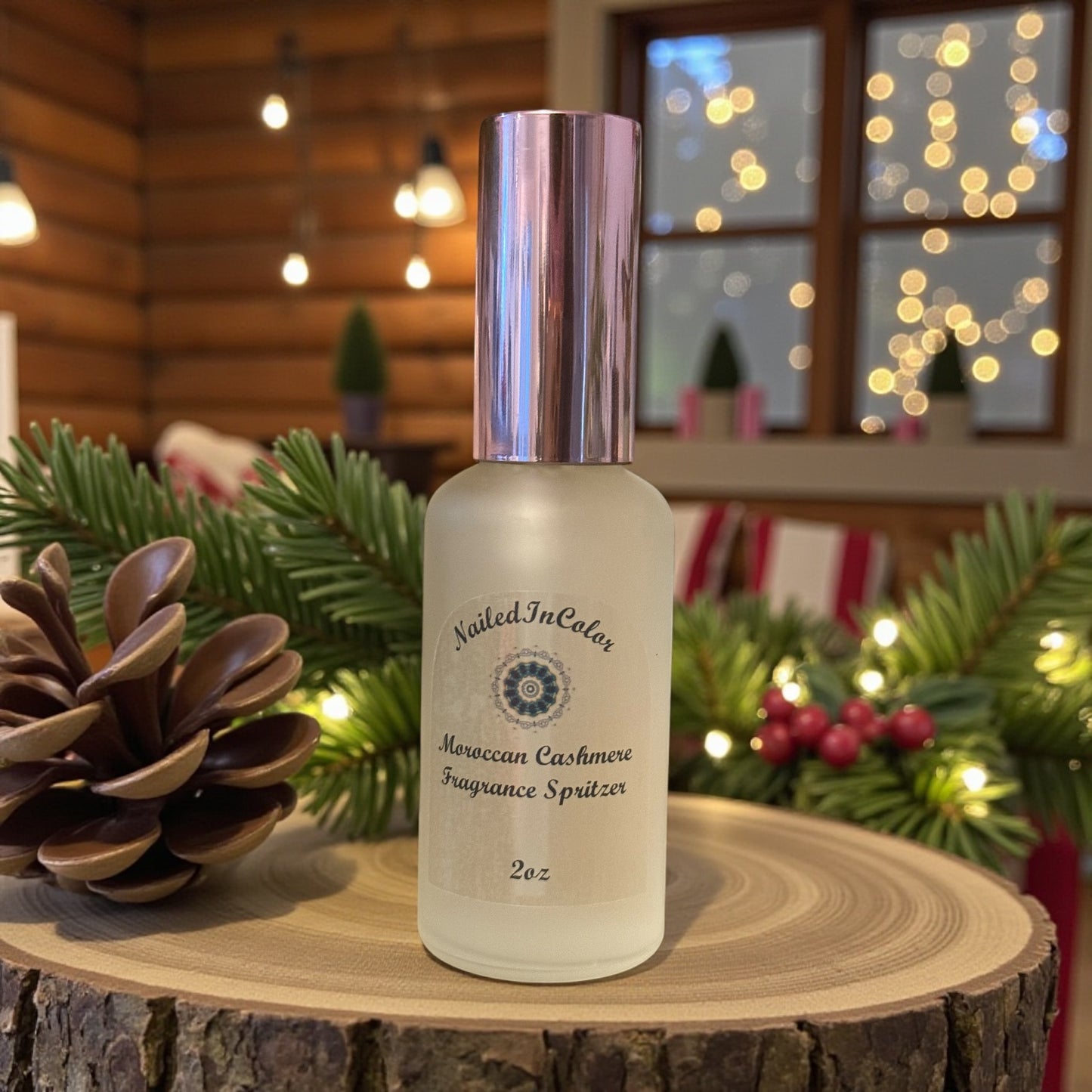 Moroccan Cashmere fragrance spritzer bottle on a wooden surface with festive background