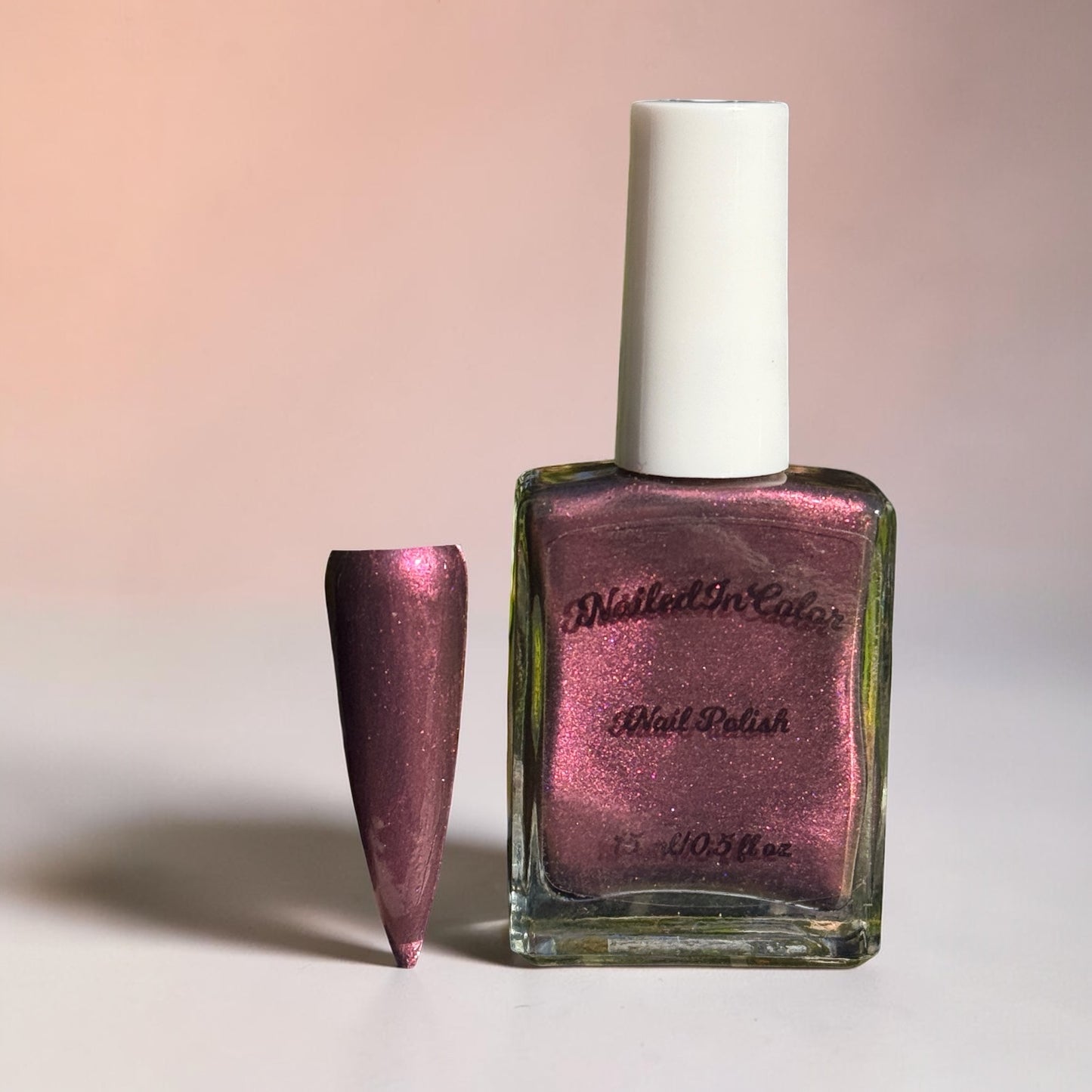 Dusky Wine deep mulled wine nail polish bottle on a pastel background
