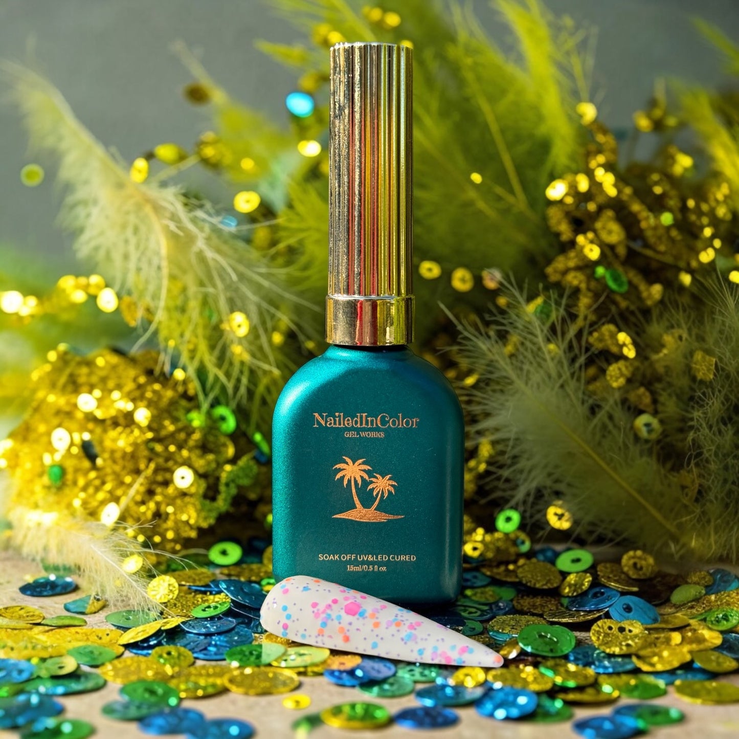 NailedInColor gel polish bottle with decorative feather, and sequin elements on a colorful background
