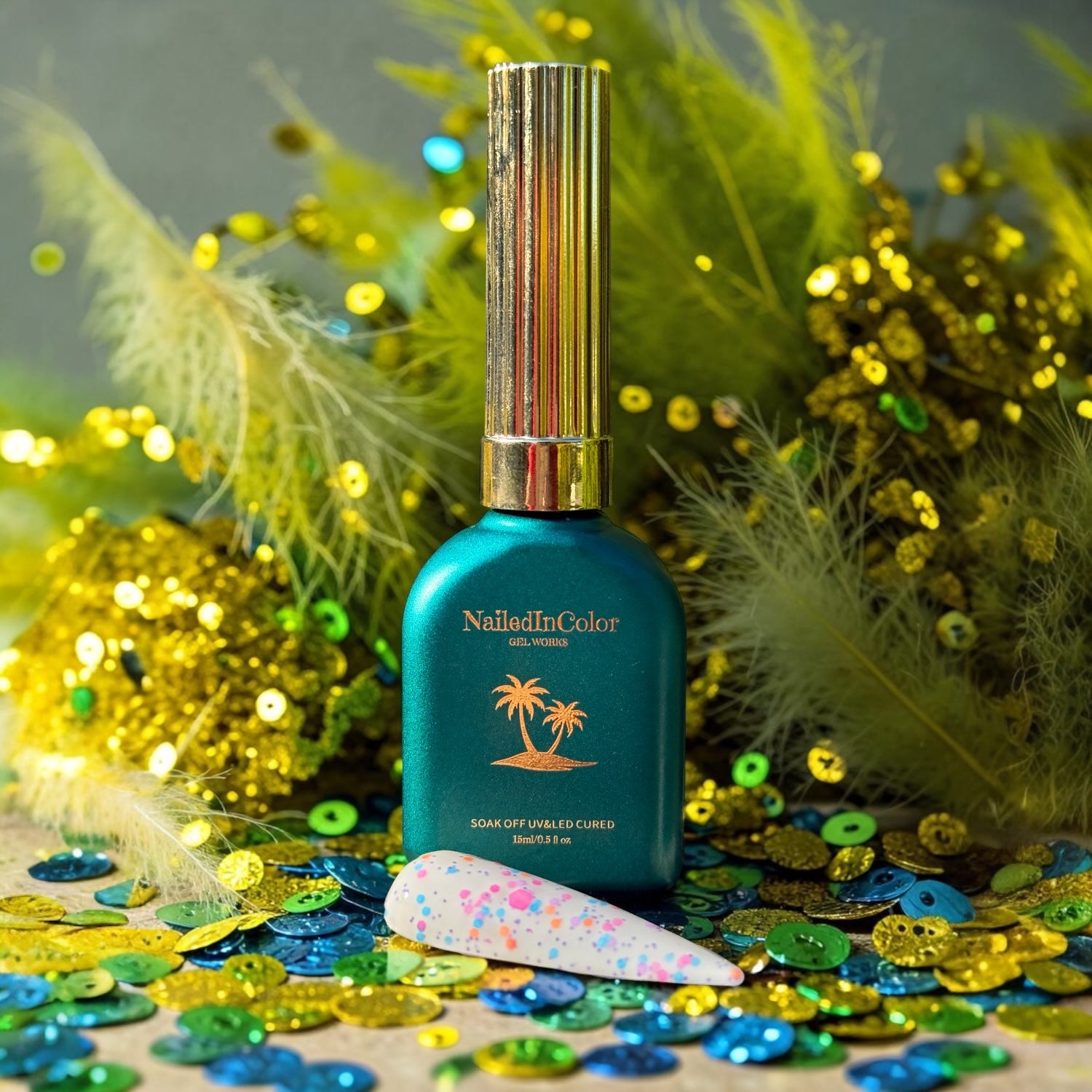 NailedInColor gel polish bottle with decorative feather, and sequin elements on a colorful background