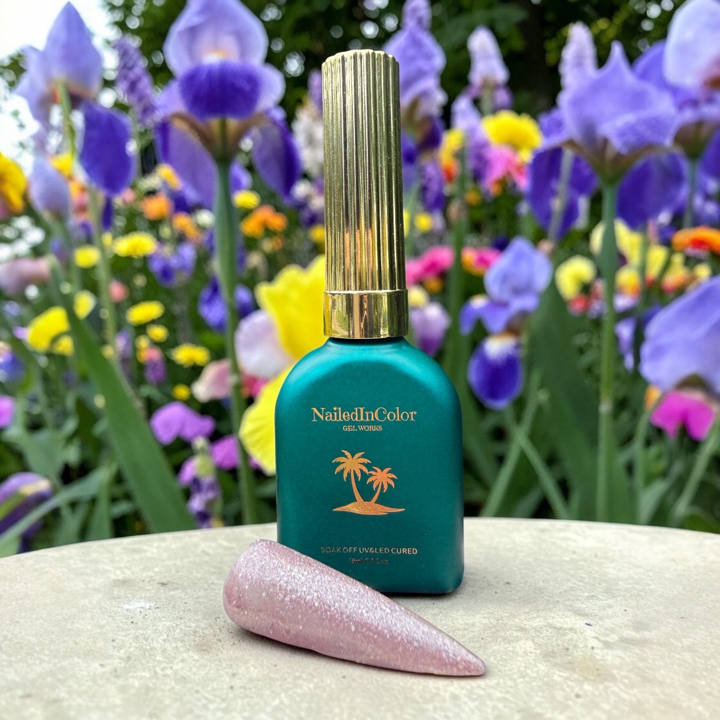 NailedInColor nail polish bottle with a lavender glittery nail tip against a floral background