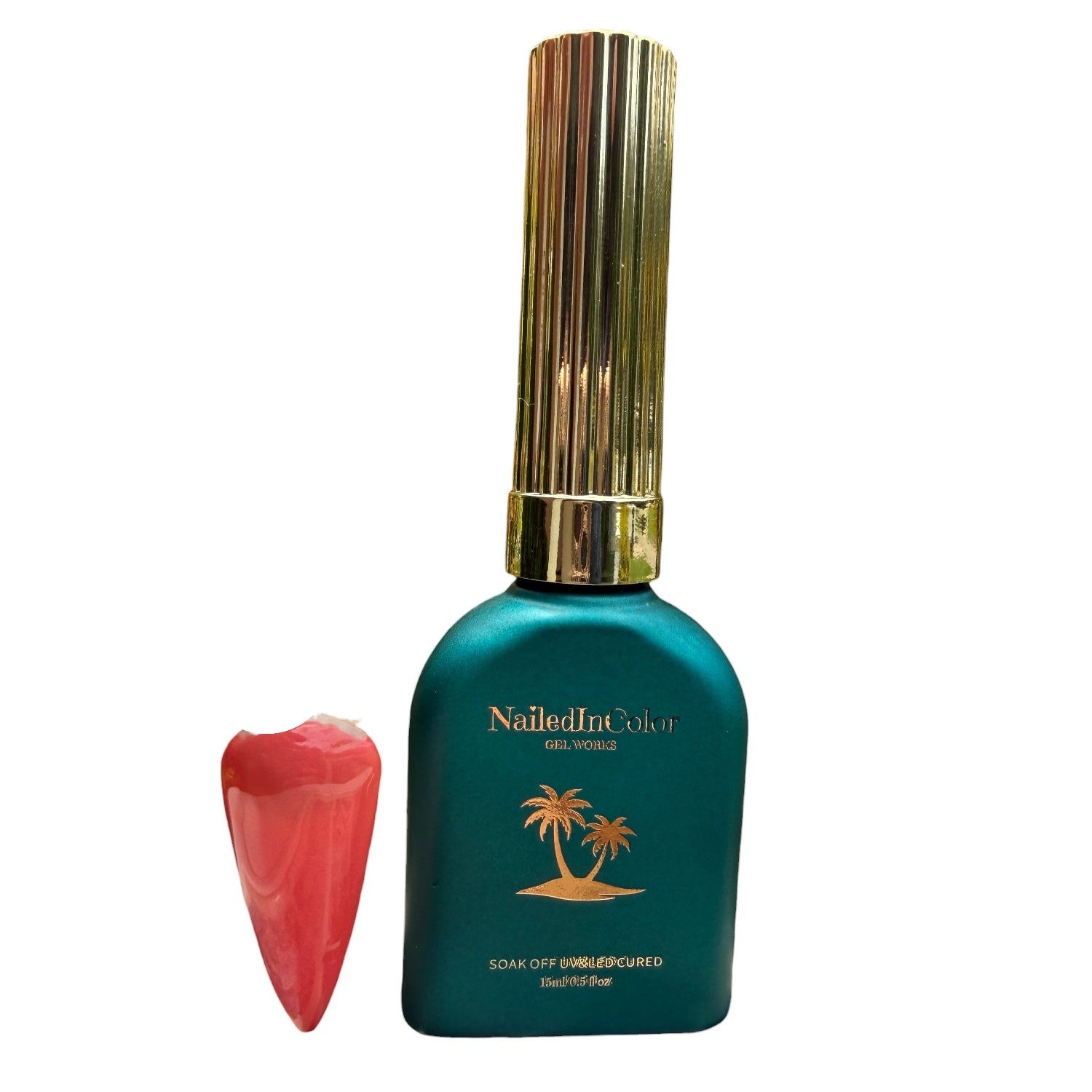 NailedInColor nail polish bottle with a gold cap and palm tree design on a white background with a coral polished nail swatch