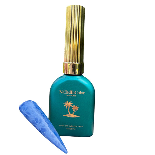 Teal nail polish bottle with gold cap and blue nail sample on a white background