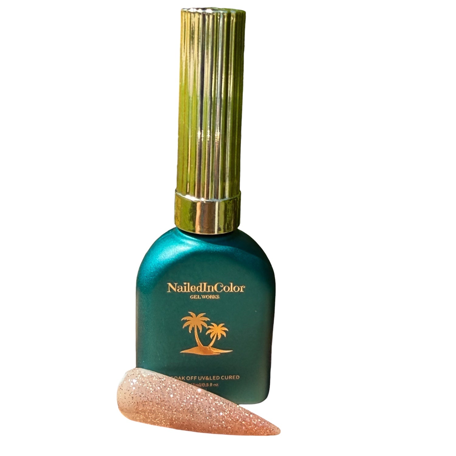 Nailed In Color nail polish bottle with a gold cap and a glittery nail swatch on a white background