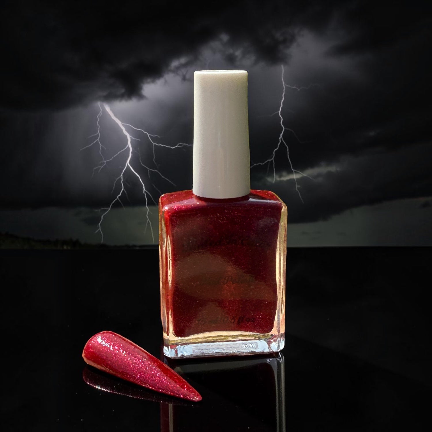 Red nail polish bottle with a white cap  and a red glittery nail swatch on a reflective surface against a dark background with lightning.