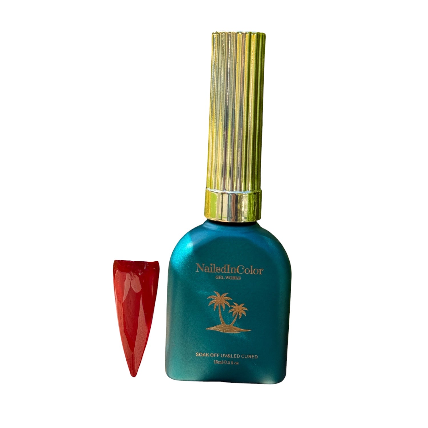 Green nail polish bottle with gold cap and red nail swatch on a white background