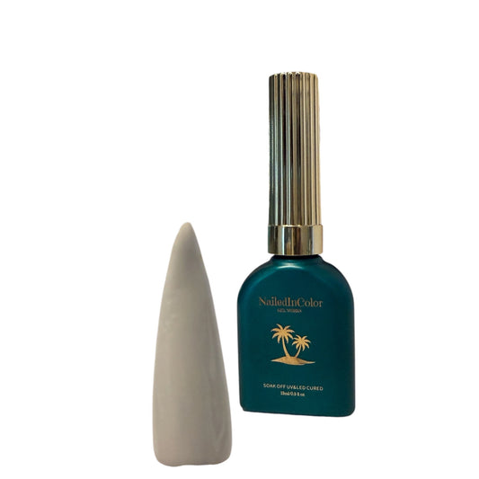 white nail tip with a teal green with a gold cap polish bottle on a white background