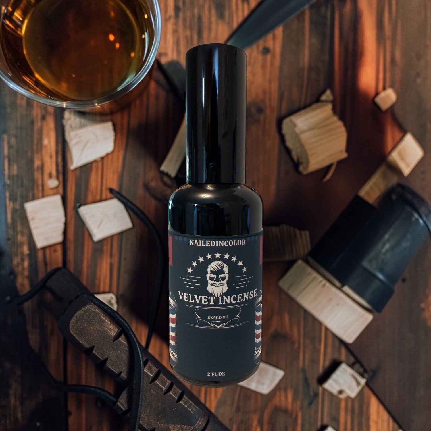 A bottle of Nailed in Color Velvet Incense with a black cap and black label, styled on a rustic wooden background and whiskey glass.