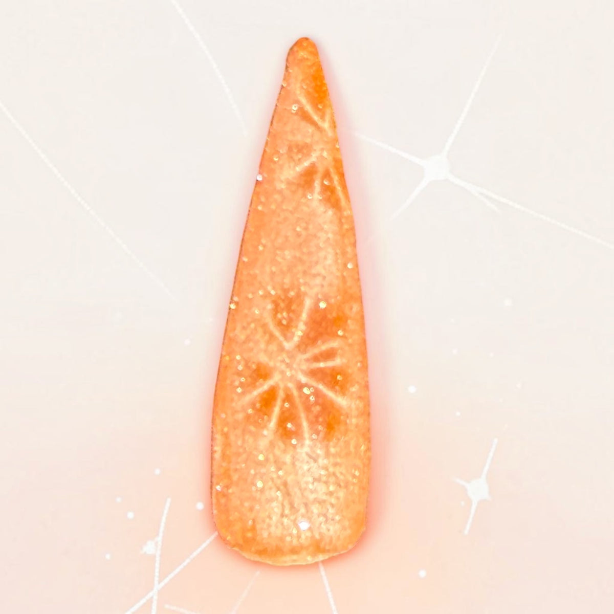 Fall orange color cat eye nail swtch on pale background with star burst effect