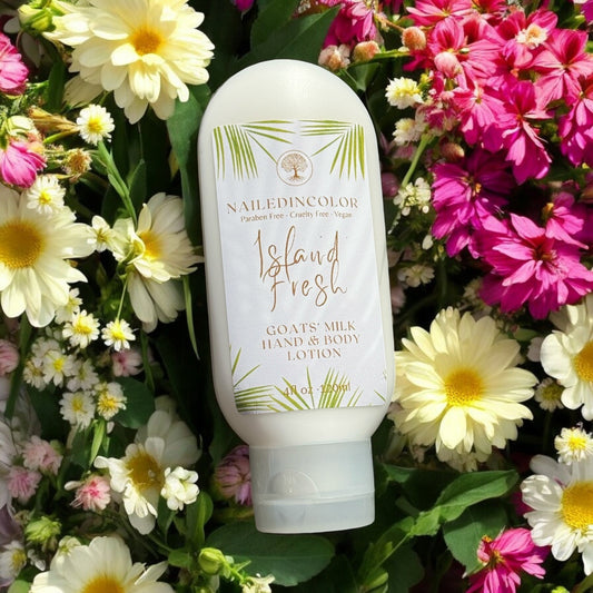 bottle of Island Fresh goats' milk lotion resting on flowers